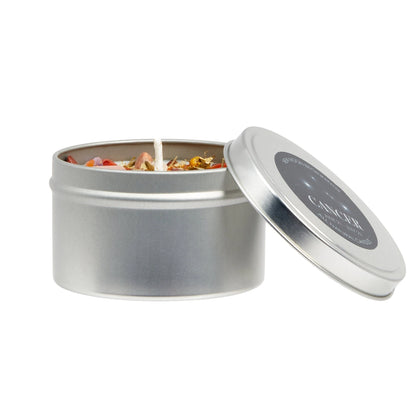 Silver tin candle with floral elements on a white background