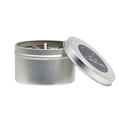 Silver candle tin with a candle inside on a white background